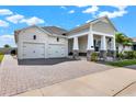 Beautiful single-story home featuring a two-car garage and a paver driveway at 5499 Orange Orchard Dr, Winter Garden, FL 34787