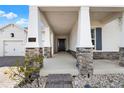 Inviting front porch with stone accents and a covered entrance leading to the home at 5499 Orange Orchard Dr, Winter Garden, FL 34787