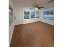 Bright living room with new wood flooring, plenty of light from multiple windows, and a ceiling fan at 636 Coke Ave, Winter Garden, FL 34787