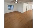 Spacious living room with light hardwood floors, ceiling fan, and crisp white walls at 636 Coke Ave, Winter Garden, FL 34787