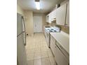 Efficient kitchen featuring white appliances and tile flooring at 725 Northlake Blvd # 66, Altamonte Springs, FL 32701