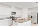 Modern kitchen featuring white cabinets, stainless steel appliances, and a center island at 792 Griffon Ave, Lake Alfred, FL 33850