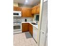 Efficient kitchen has white appliances, modern countertops, and a stainless steel sink at 9 Escondido Cir # 88, Altamonte Springs, FL 32701