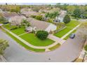 Beautiful aerial view of a home on a corner lot with mature trees and landscaping at 1145 Lake Rogers Cir, Oviedo, FL 32765
