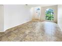 Bright living room with tile flooring and a large window at 1168 Ballyshannon Pkwy, Orlando, FL 32828