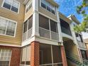 Exterior shot of a condo building featuring a screened porch, brick facade, and multiple levels of balconies at 13037 Mulberry Park Drive Dr # 529, Orlando, FL 32821