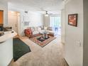 Bright living room featuring neutral carpet, a decorative rug, a comfortable sofa, and a sliding door to the patio at 13037 Mulberry Park Drive Dr # 529, Orlando, FL 32821