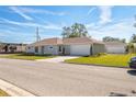 Well-maintained one-story home with an attached garage, a green lawn, and a paved driveway at 1802 Dixie Belle Dr, Orlando, FL 32812