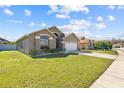 Charming single-story home featuring a well-manicured lawn and a two-car garage at 2422 Black Powder Ln, Kissimmee, FL 34743