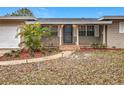 Inviting front porch with brick accents, walkway lighting and a well-maintained front yard offering great curb appeal at 2805 Grassmere Ln, Orlando, FL 32808