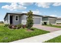Charming single-Gathering home with a well-maintained lawn, brick driveway, and manicured landscaping at 3189 Viceroy Ct, Poinciana, FL 34759