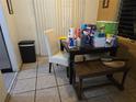 Dining area with a table and chair cluttered with various items and cleaning products at 39 N Oxalis Dr, Orlando, FL 32807