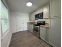 Well-lit kitchen featuring stainless steel appliances, granite countertops, and shaker style cabinets at 4005 Clarcona Ocoee Rd, Orlando, FL 32810