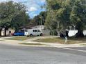 Cozy single-story home with lush trees, adjacent parking, and a classic van at 4007 Clarcona Ocoee Rd, Orlando, FL 32810