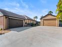 Long concrete driveway leading to the main house and a separate two-car garage at 448 Warrior Trl, Deltona, FL 32725