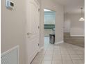 Inviting tiled hallway leading to the kitchen and living area, showcasing a seamless transition between spaces at 4865 Cypress Woods Dr # 2105, Orlando, FL 32811