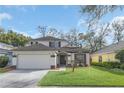 Charming two-story home with a well-manicured lawn, a two car garage, and classic architectural detailing at 5021 Sweet Leaf Ct, Altamonte Springs, FL 32714