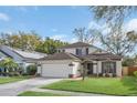 Charming two-story home with a well-manicured lawn, a two car garage, and classic architectural detailing at 5021 Sweet Leaf Ct, Altamonte Springs, FL 32714