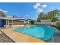 Refreshing in-ground pool surrounded by a concrete patio and a screened-in lanai at 5073 Lake Howell Rd, Winter Park, FL 32792