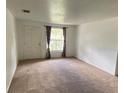 Bright living room featuring neutral walls, carpet flooring, and a window with curtains at 510 Lavon Dr, Altamonte Springs, FL 32701