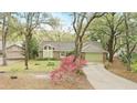 Charming single-story home with brick facade, green garage door, and mature landscaping at 5849 Groveline Dr, Orlando, FL 32810