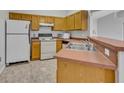 Kitchen featuring matching white appliances, cabinets, and neutral countertops at 609 Bluebill Ln, Kissimmee, FL 34759