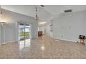 Open floor plan living room with tile flooring, sliding door and dining area at 609 Bluebill Ln, Kissimmee, FL 34759
