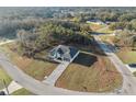 Striking aerial view of a charming home featuring a driveway and lush green landscape at 6430 Sw 145Th Ln, Ocala, FL 34473