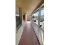 Wide shot of an exterior balcony with white railings and view of a parking lot at 709 Michigan Ct # 4, St Cloud, FL 34769