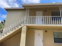 Two story apartment building close up view showing the entrance door of units 2 and 4 at 709 Michigan Ct # 4, St Cloud, FL 34769