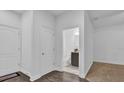 Bright hallway with fresh white paint, opening to a bathroom with modern fixtures and a dark vanity at 1012 Parma Cir, Lake Mary, FL 32746