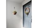 A charming entryway with a decorated blue door and hanging flower basket at 1109 Clubside Dr # 1109, Longwood, FL 32779