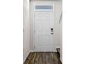 Inviting front door with modern digital lock and sidelight window, enhancing security and natural light at 2171 Longleaf Rd, Davenport, FL 33837