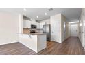 Modern kitchen with granite countertops, stainless steel appliances and sleek white cabinetry at 2171 Longleaf Rd, Davenport, FL 33837