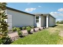 Exterior view featuring a tidy lawn and a brick paver walkway leading to a welcoming front entrance at 2513 Merseyside Ct, Haines City, FL 33844