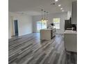 Bright kitchen with an island, sleek countertops, stainless steel appliances, and modern pendant lighting at 2693 Sw 153Rd Place Rd, Ocala, FL 34473