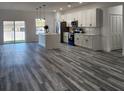 Open-concept kitchen featuring an island, sleek countertops, stainless steel appliances, and stylish pendant lighting at 2693 Sw 153Rd Place Rd, Ocala, FL 34473