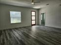 Bright living room featuring hardwood floors, a front door with glass inserts, and a ceiling fan at 2693 Sw 153Rd Place Rd, Ocala, FL 34473