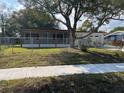 Charming single-story home featuring a screened in porch and an attached one car garage at 2818 Geoffrey Dr, Orlando, FL 32826