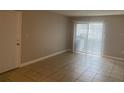Living room with neutral paint, tile floors, and sliding glass doors to the outdoor area at 314 Cherokee Ct # A, Altamonte Springs, FL 32701