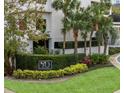 Well-manicured entrance to '530 East Central' with lush greenery and colorful landscaping, creating an inviting approach at 530 E Central Blvd # 303, Orlando, FL 32801