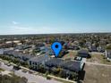 Aerial view showcasing the neighborhood with beautiful homes and well-maintained landscaping at 7464 Gathering Dr, Reunion, FL 34747