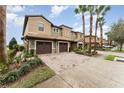 Charming townhomes feature a paved driveway, 1-car garage, and a tile roof, complemented by well-maintained landscaping and palm trees at 8924 Azalea Sands Ln # 8924, Davenport, FL 33896