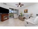 Bright living room with a fireplace, comfortable seating, and a ceiling fan at 8924 Azalea Sands Ln # 8924, Davenport, FL 33896