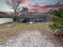 Backyard featuring a screened-in porch, landscaping, and a partial above ground pool at 1067 Lyric Dr, Deltona, FL 32738