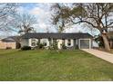 Charming single-story home with mature trees and a well-maintained lawn at 1067 Lyric Dr, Deltona, FL 32738