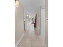 Bright hallway with tile flooring leading to a courtyard view with ample natural light at 111 Autumn Dr, Longwood, FL 32779