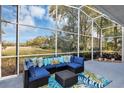 Enjoy the weather in this screened lanai with comfortable wicker seating and views of the landscaped backyard at 1141 Sweet Heather Ln, Apopka, FL 32712