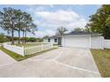 Wide driveway leading to a well-maintained single-story home, complete with a white picket fence at 1497 Jay St, Longwood, FL 32750