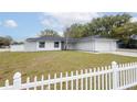 Inviting single-story home with a classic design, accented by a white picket fence and lush greenery at 1497 Jay St, Longwood, FL 32750